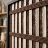 Macro detail of Cocoa Cadence textured textile art highlighting thick brown and cream yarn beside the black frame.