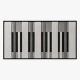 Front studio view of Monochrome Tempo textured wall art featuring a black, white, and grey piano-key geometric pattern in a black frame.