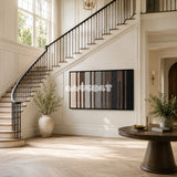Umber Columns soft cotton cord fiber art with rhythmic vertical bands displayed in a quietly dramatic living space.