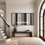 Ivory Structure cream, grey, and black textile wall art displayed in a polished modern interior.