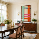 Framed Pop Boulevard woven wall hanging with citrus orange, mint, pink, blue, and cream geometry in a refined room.