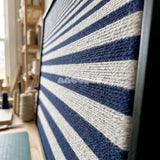 Detail of Linear Gradient framed textile wall art, featuring navy blue and light grey horizontal cotton cord stripes graduating from fine to broad bands.