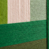 Close-up of Evergreen Harmony handcrafted textile art showing layered green tones and rich soft cotton cord texture.