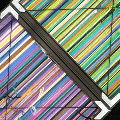 Angled close-up of Reconstructing the Future yarn wall art highlighting vibrant looped wool texture and precise stripe transitions.
