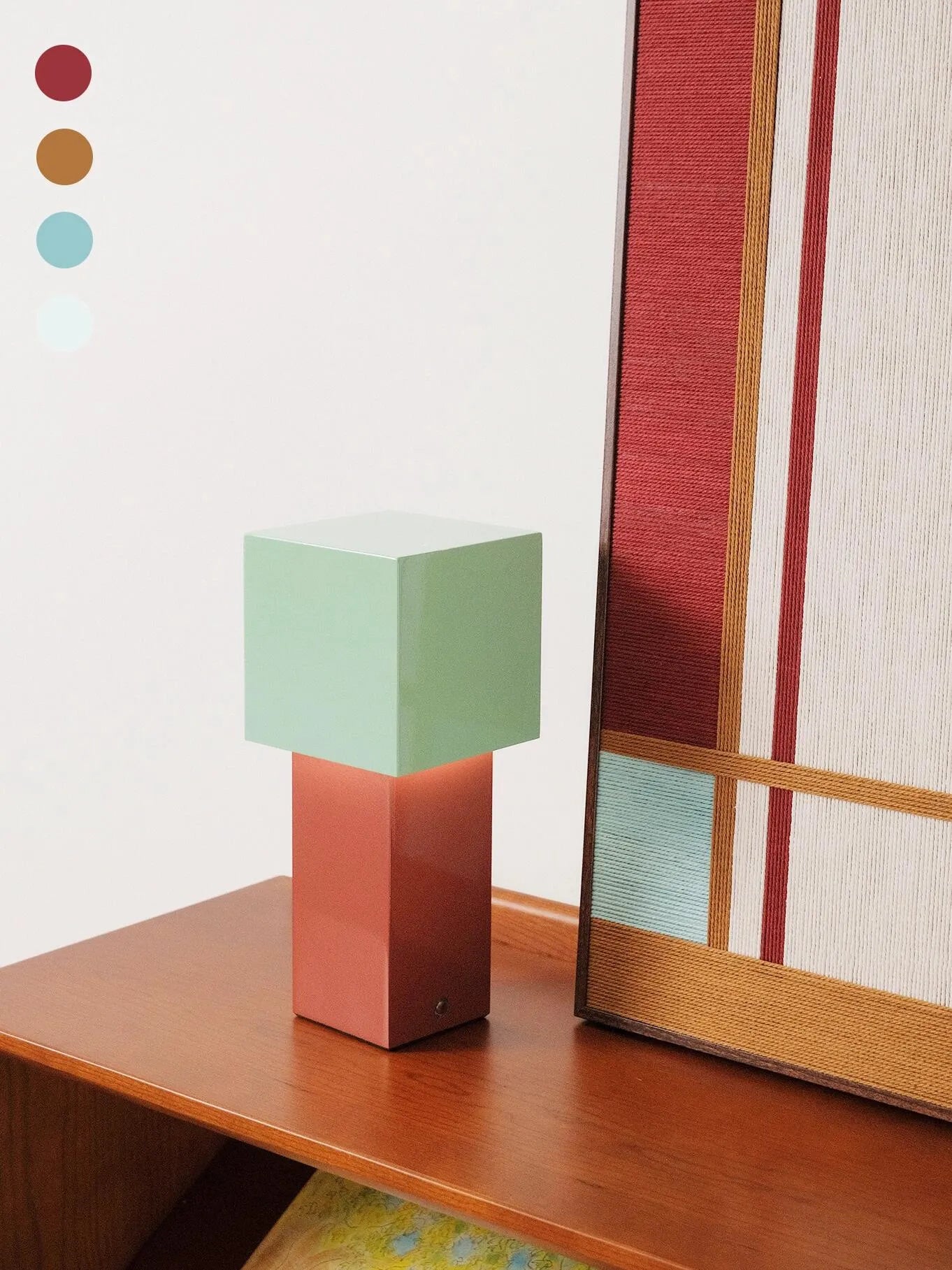 Detailed view of Red House wall art alongside geometric decor blocks on the desk, highlighting its modern color-block design and tactile wool texture.
