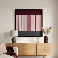 Large hand-woven wool wall art in burgundy and pink tones hanging above a wooden sideboard in a modern living room.