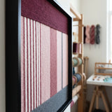 Side view of the framed soft cotton cord wall art in a studio setting showing the depth and three-dimensional texture of the woven fibers.