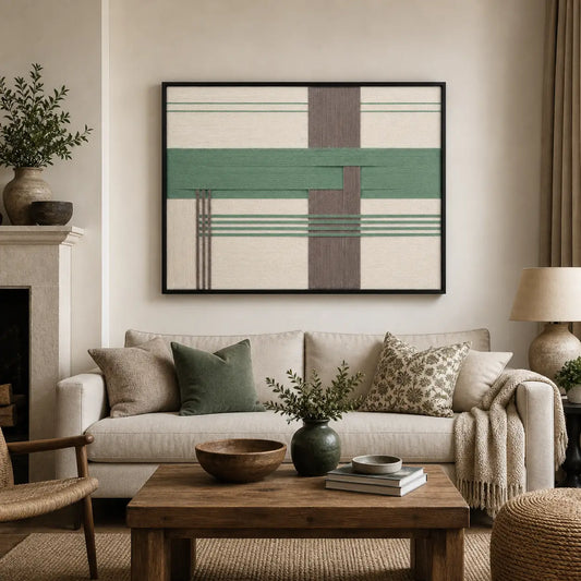 Framed Sage Crossing hand-woven wall art displayed above a cozy beige sofa in a modern, neutral-toned living room setting.