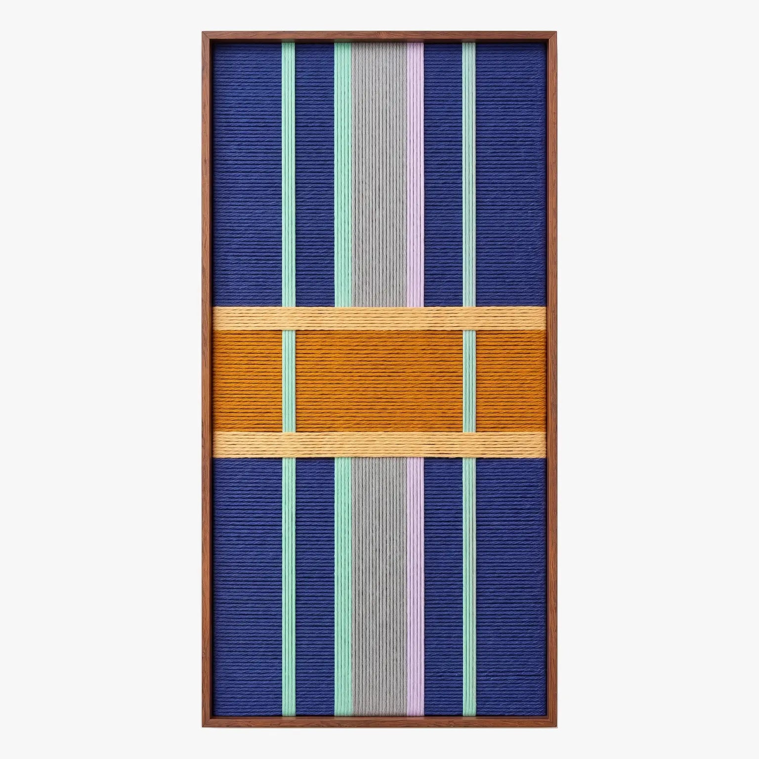 Full product shot of the vertical hand-woven wool wall art in a sleek wooden frame, highlighting its geometric pattern and mustard block.