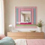 Secret Crush pink, aqua, fuchsia, and green yarn-framed mirror displayed above a pale wood dresser in a pastel modern bedroom.