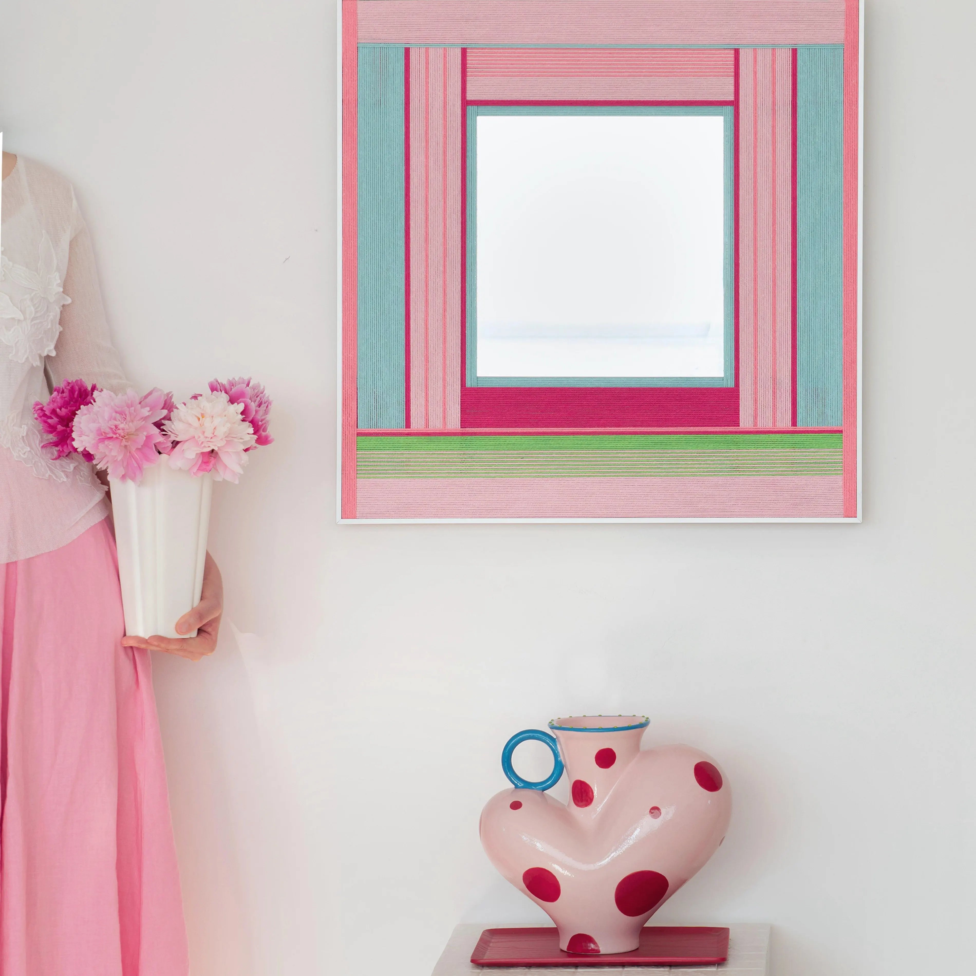 Secret Crush wall art mounted in a pastel bedroom setting next to a teddy bear and lamp, emphasizing its playful color-block design.
