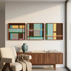 Large three-piece Sedona Red Thread textile wall art set featuring teal, brown, and beige geometric patterns hanging above a mid-century wooden sideboard and cream armchair.