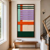 A cozy living room featuring the Sedona Twilight hand-woven wool tapestry mounted on a wall above a wooden bench.
