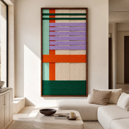 Sedona Twilight framed hand-woven wall art hanging above a plush sofa in a sunlit modern living room setting.