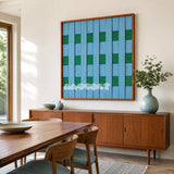 Seine Riverbank blue and green geometric yarn wall art displayed above a wooden sideboard in a bright dining room.