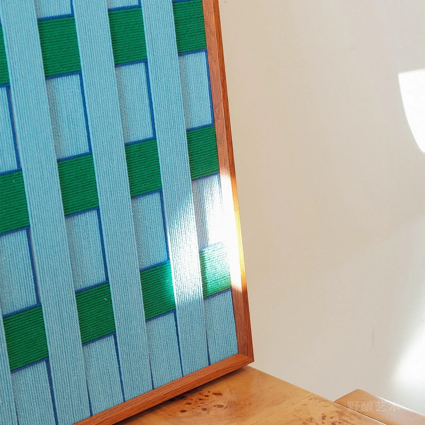 Close-up of Seine Riverbank yarn wall art revealing tight hand-woven texture and seamless transitions between sky-blue and emerald-green fibers
