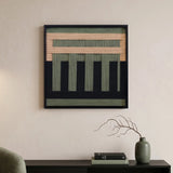 soft cotton cord wall art with forest green and tan geometric patterns hanging above a black console table with minimalist decor.