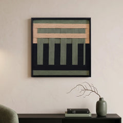 Hand-woven wool wall art with forest green and tan geometric patterns hanging above a black console table with minimalist decor.