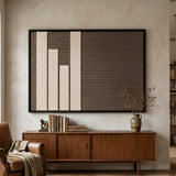 Silent Stelae hand-woven wool art displayed above a dark wood console table, styled with books and vases for a sophisticated interior look.