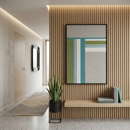 Vertical framed fiber wall art styled in a modern entryway with slatted wood wall panels and a minimalist bench.