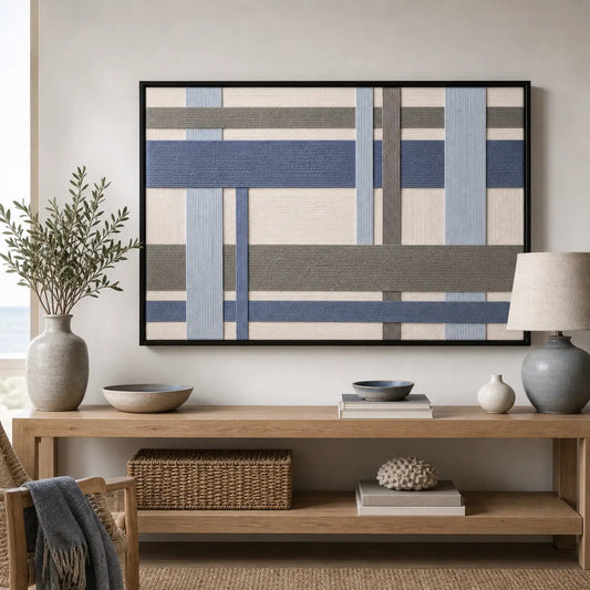 Framed Slate Harbor hand-woven wall art displayed above a light wood console table in a serene living room setting.