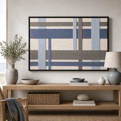 Framed Slate Harbor hand-woven wall art displayed above a light wood console table in a serene living room setting.