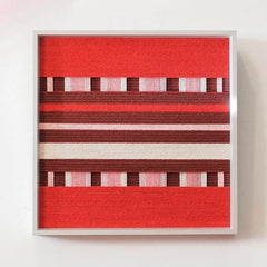 Front view of Spring Miss yarn wall art showing its exact square format and alternating red, burgundy, and cream stripes on a clean white background.
