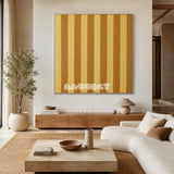 Hana and Alice SQ003 gold and ochre striped soft cotton cord wall art above a wood console in a calm neutral living room