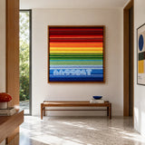 Rainbow SQ004 spectrum colored soft cotton cord wall art above a wood bench in a bright modern entryway