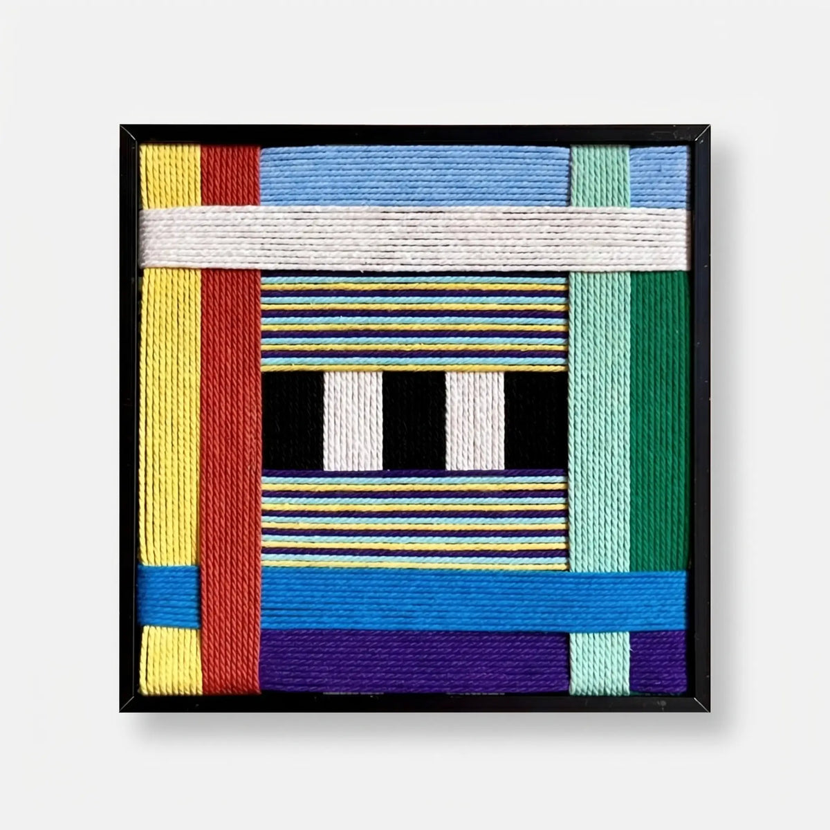 Front view of Childhood Old Toys SQ005 soft cotton cord wall art with colorful geometric blocks and black and white bars