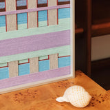 Close-up of Hanosen Anji SQ010 soft cotton cord wall art showing lavender mint blue cream and red layered weave beside a seashell