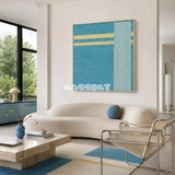 Infinite Serenity SQ020 blue and yellow framed yarn art above a curved white sofa in a bright modern living room