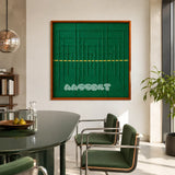 Green Shadow Weave SQ025 emerald green framed yarn art above a green table in a sunlit modern dining room