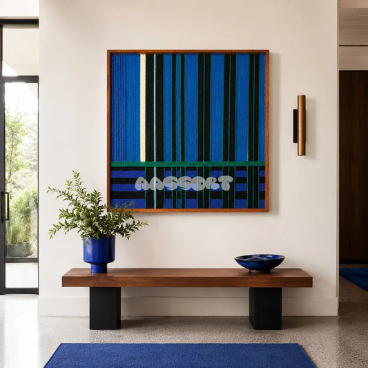 Summer Night's Serenity SQ026 blue black and green framed yarn art above a wood bench in a bright modern entryway