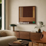 Earthy Fragrance SQ028 brown tan and green framed yarn art above a walnut sideboard beside a leather chair in a warm living room