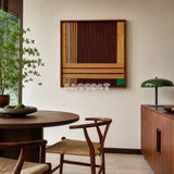 Earthy Fragrance SQ028 brown tan and green framed yarn art above a round wood table in a warm dining room