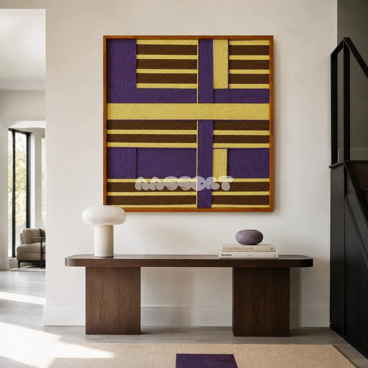 Mrs. Maisel SQ036 purple brown and yellow framed yarn art above a dark wood console table in a bright modern entryway