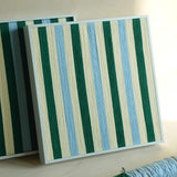 Two Spring Lake SQ039 green blue and cream striped framed yarn artworks shown together from the front in the studio
