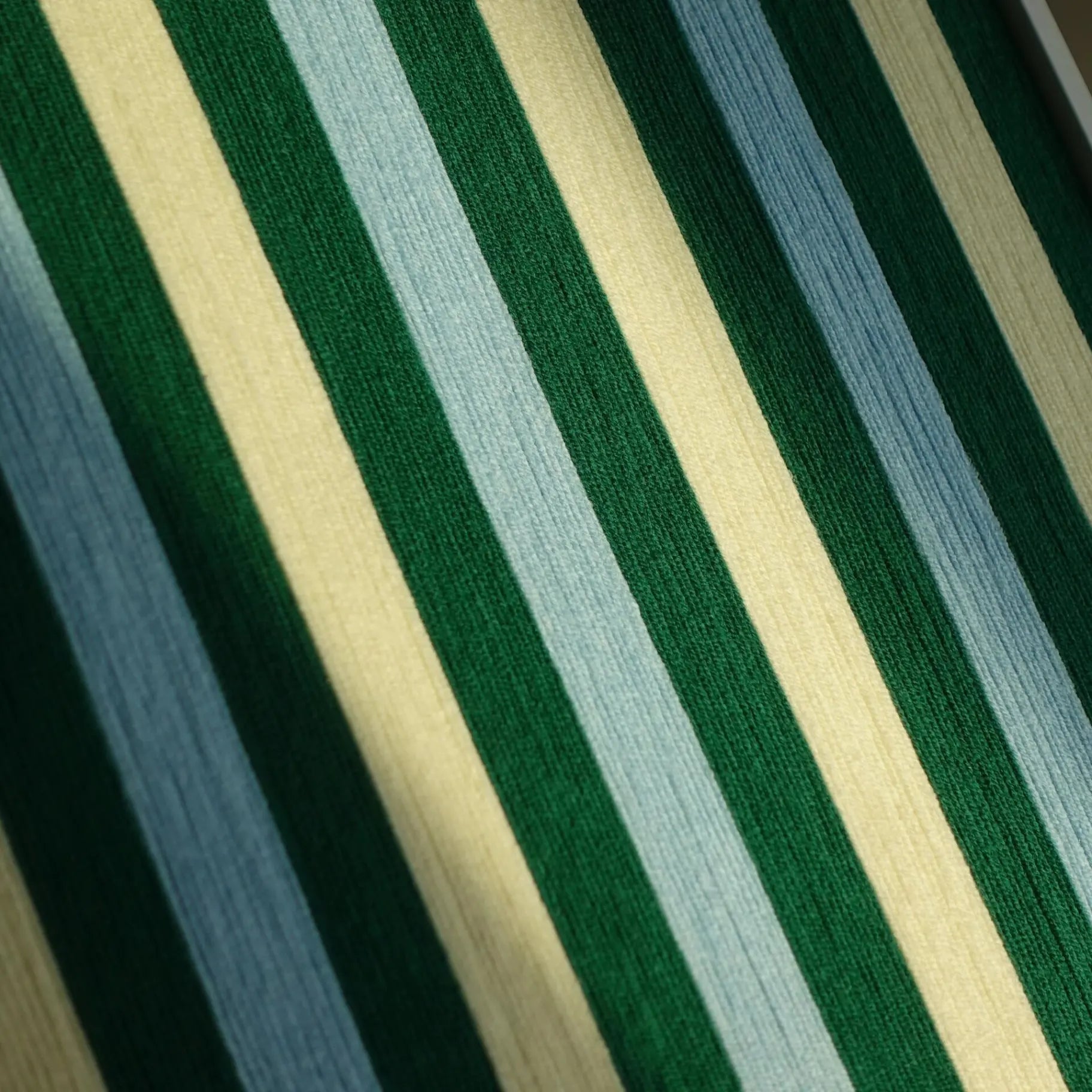Macro close-up of Spring Lake SQ039 showing the dense green blue and cream vertical yarn stripes and tactile fiber texture
