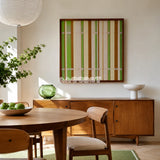 Tree Ah Tree SQ042 green cream and brown framed yarn art above a wood sideboard beside a round wood table in a sunlit dining room