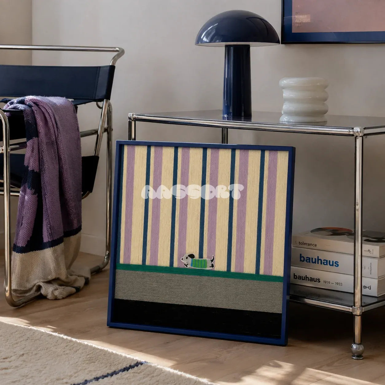 Cerulean Stripe Pup Frolic SQ047 blue lilac cream green and black framed yarn art leaning beside a chrome console in a Bauhaus style lounge