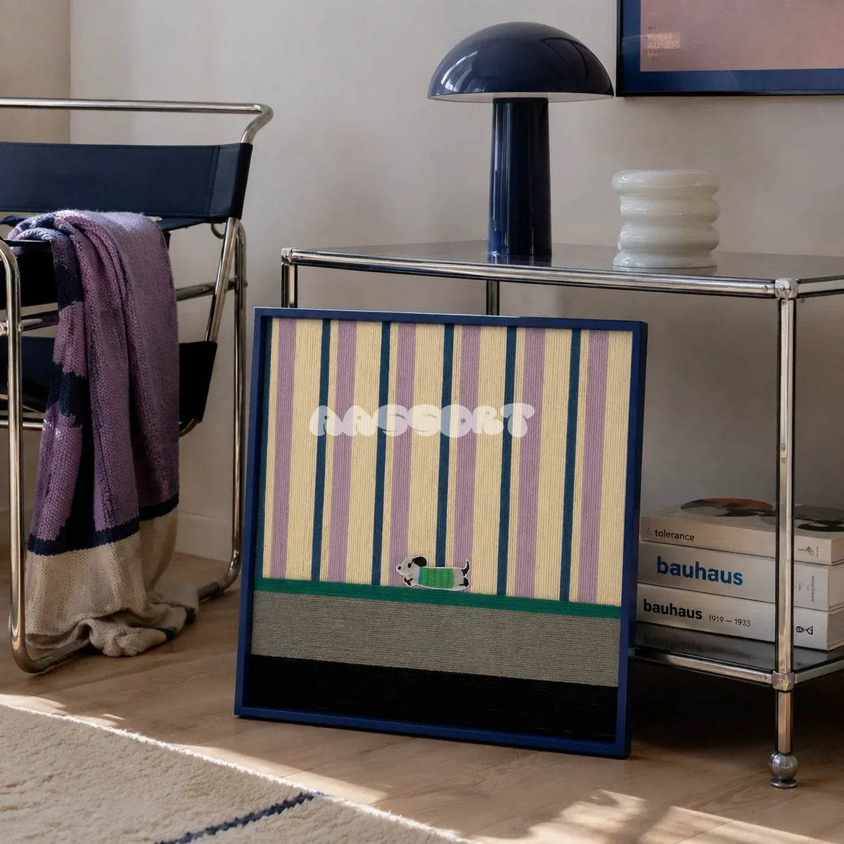 Cerulean Stripe Pup Frolic SQ047 blue lilac cream green and black framed yarn art leaning beside a chrome console in a Bauhaus style lounge