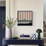 Cerulean Stripe Pup Frolic SQ047 blue lilac cream green and black framed yarn art above a navy console in a bright entryway