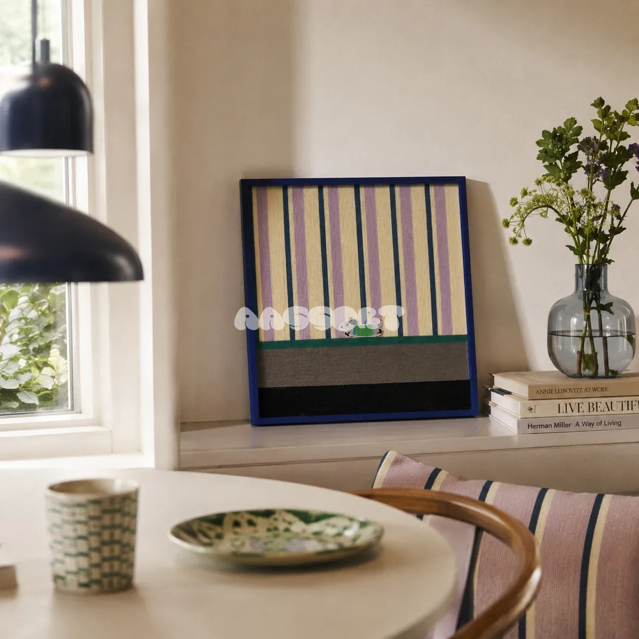 Cerulean Stripe Pup Frolic SQ047 striped framed yarn art with a dog motif displayed by a window beside a round table in a bright dining nook