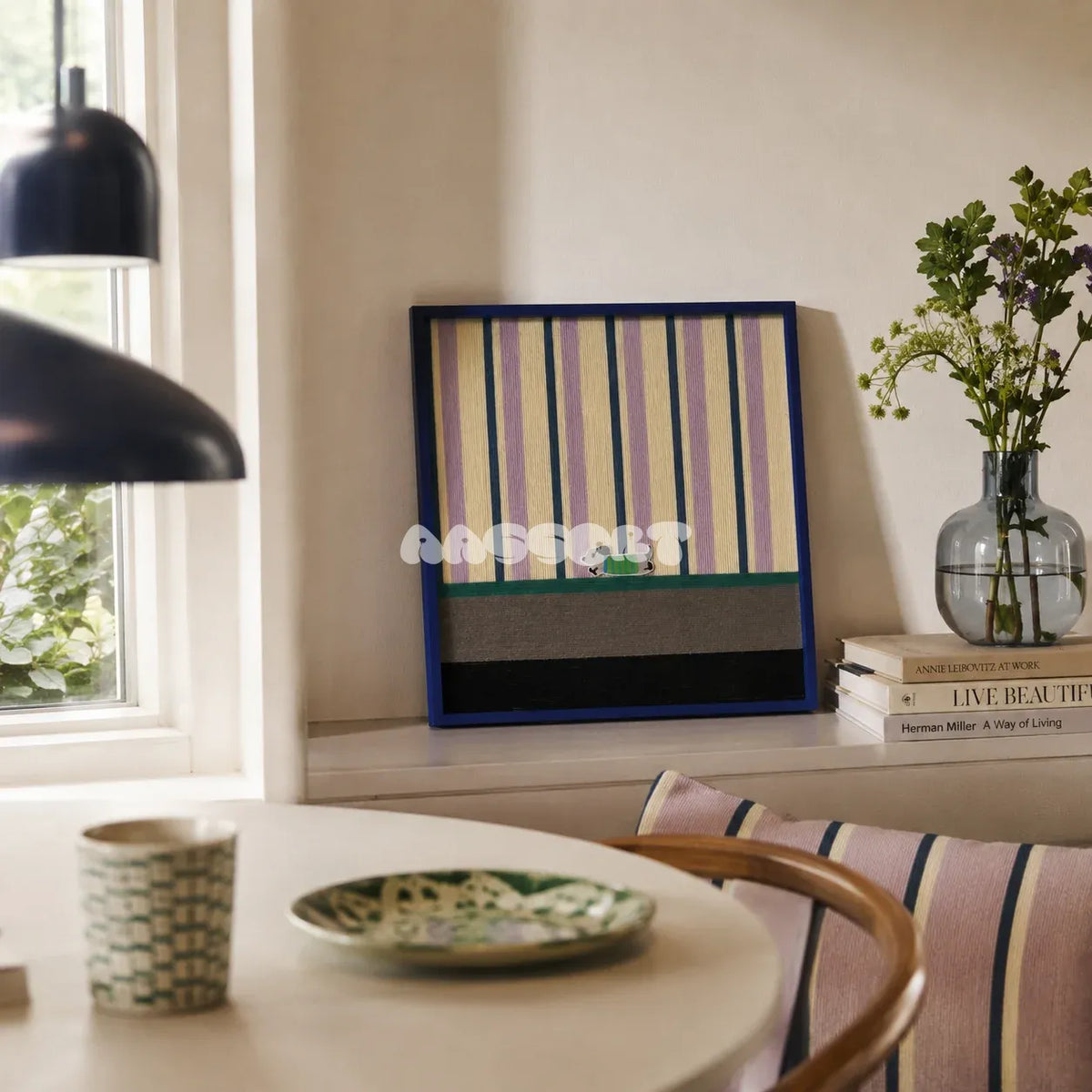 Cerulean Stripe Pup Frolic SQ047 striped framed yarn art with a dog motif displayed by a window beside a round table in a bright dining nook