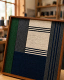 Needle and Ink SQ085 fiber art shown in an artist studio highlighting its dimensional yarn craftsmanship.