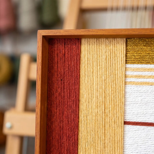 Close-up corner view of Sun-Baked Terra SQ086 highlighting tactile hand-wrapped yarn and the sleek frame finish.
