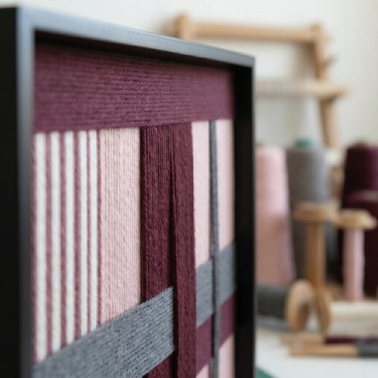 Close-up side view of Rose Coordinates SQ093 showing burgundy, dusty rose, and gray hand-wrapped yarn texture.