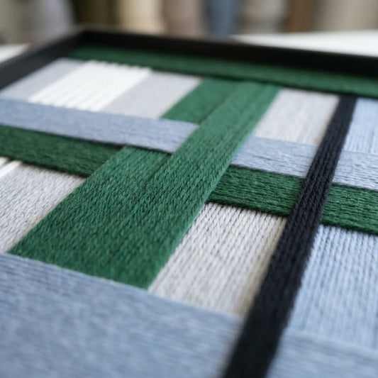 Angled view of Polar Forest SQ094 showing the dimensional depth of interlocking hand-wrapped yarn blocks.