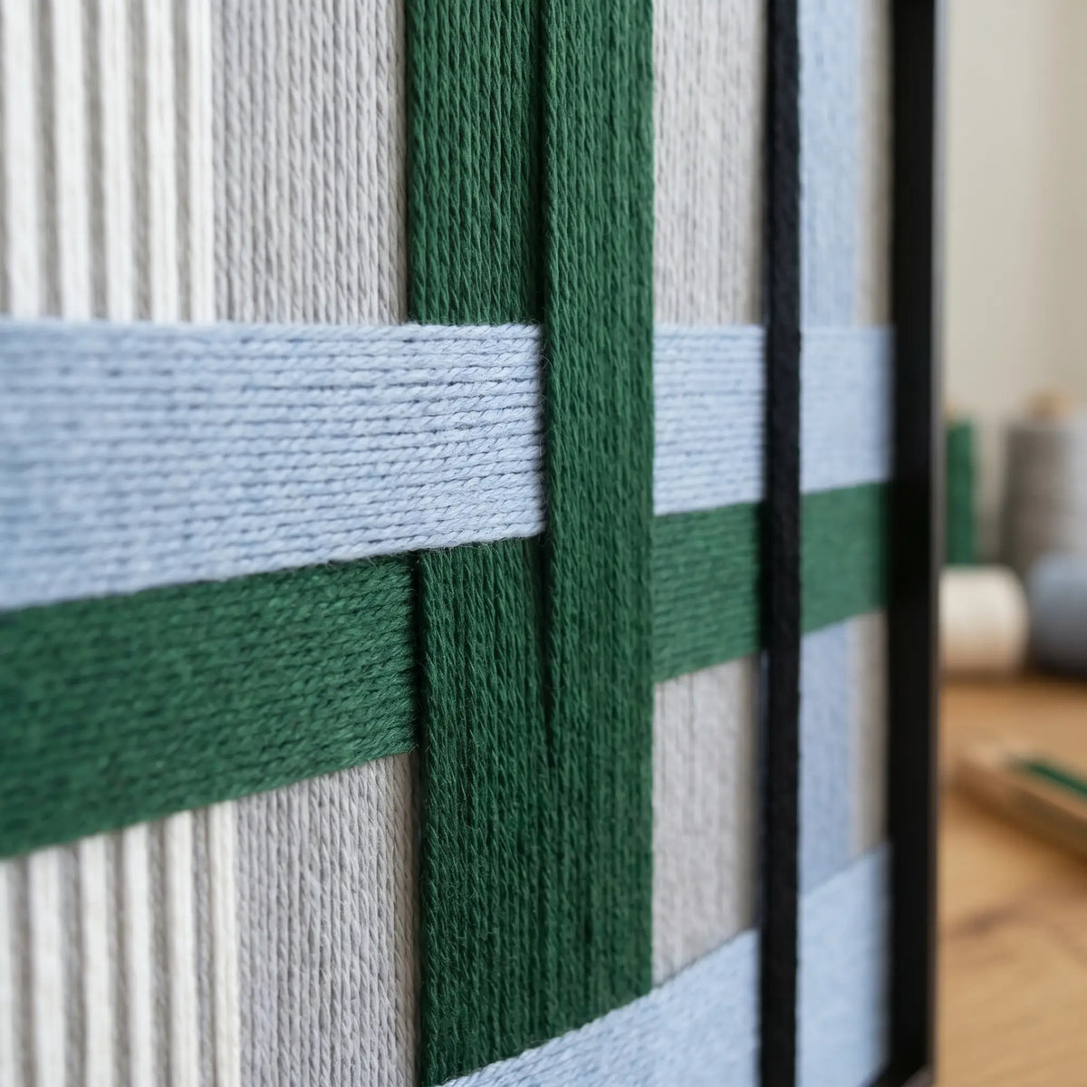 Close-up of Polar Forest SQ094 highlighting forest green and light blue soft cotton cord texture in a black frame.